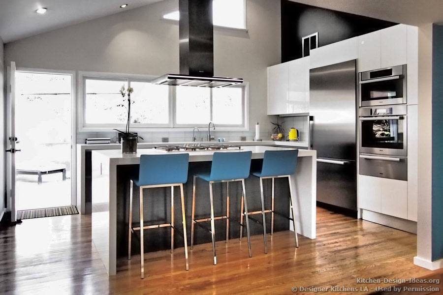 Blue bar stools provide a pop of color in this monochromatic kitchen
