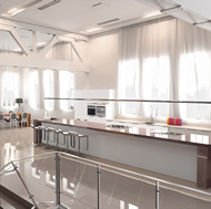 A Large Loft Kitchen with High Ceilings, Steel Beams, and Gray Compac Quartz Floors