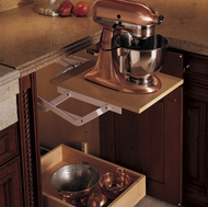 An appliance lift rises from a base cabinet and locks into place while you work.
